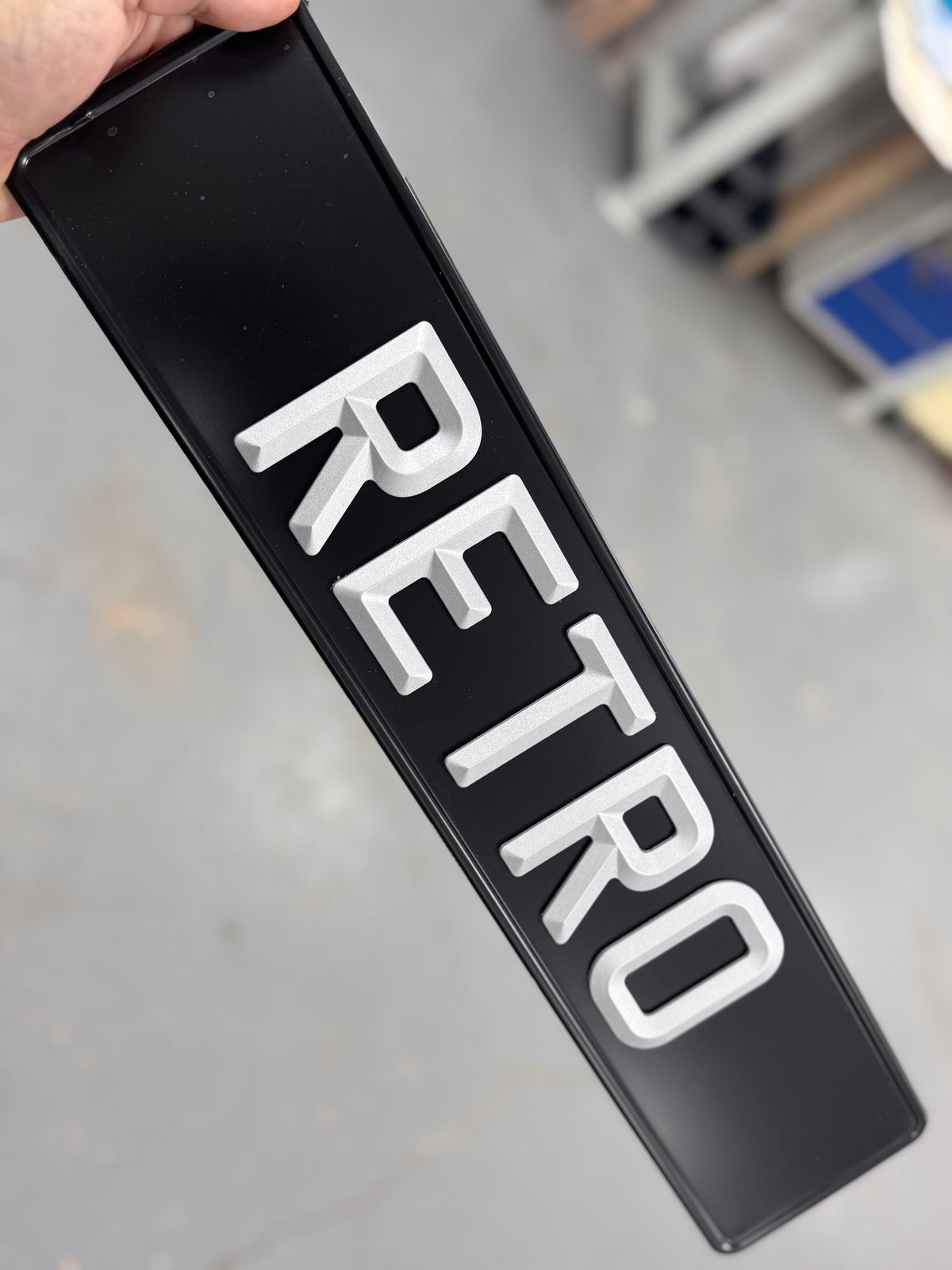 vintage number plate with the word 'retro' pressed into it 