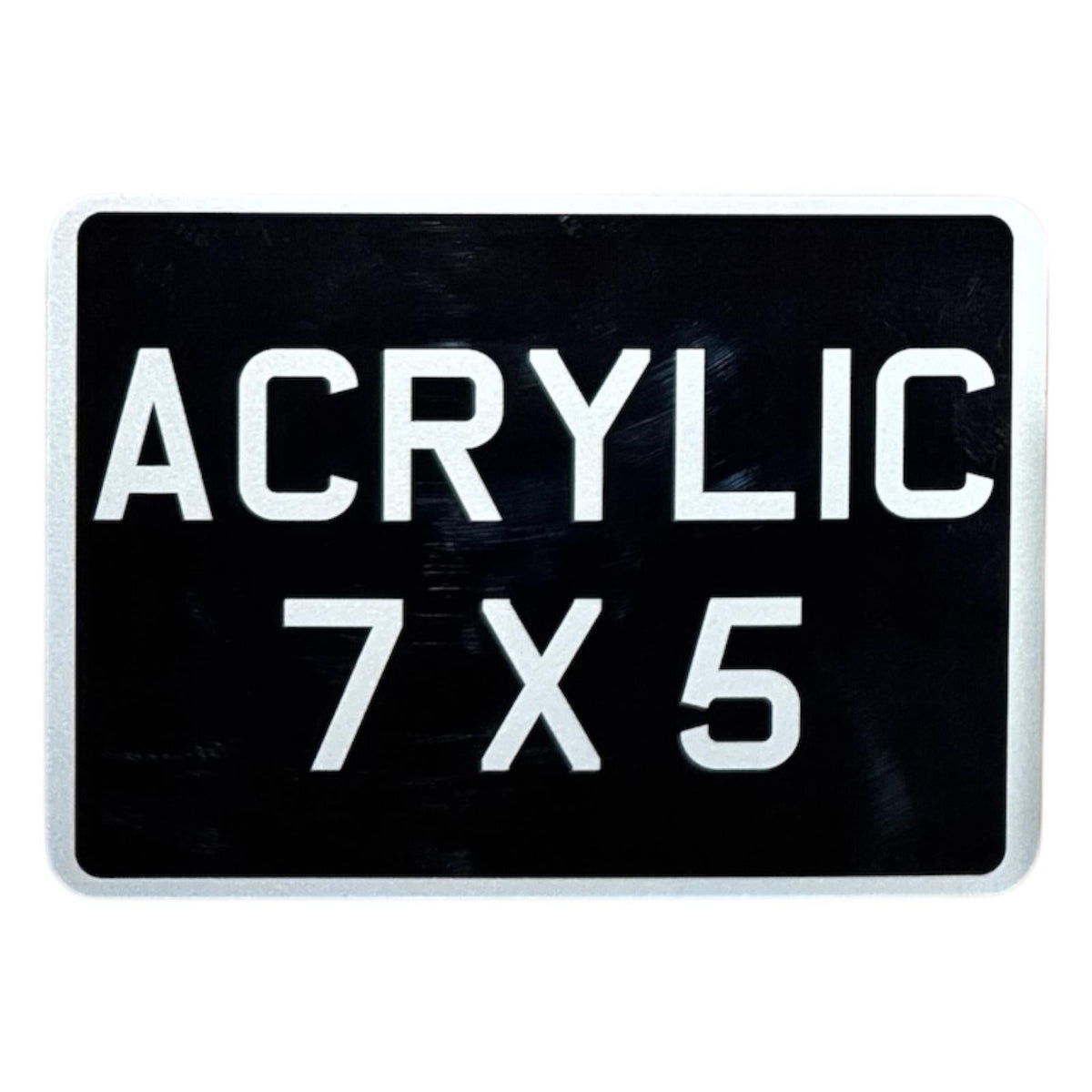 An acrylic motorcycle number plate with the text 'ACRYLIC 7X5' in bold white letters on a black background, simulating a classic vintage style.